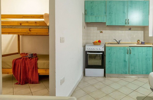 Golfo di Marinella Apartment | Beautiful apartment for 4 guests with A/C, pool, TV, patio and pets allowed