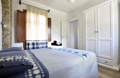 Lotzorai Apartment | Bedroom with double bed, veranda with view