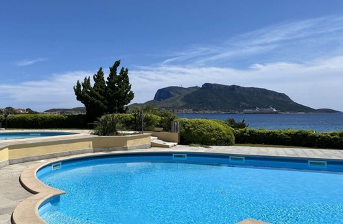 Baia Caddinas Apartment | Located in the side area of the residence, Elicriso is a one-bedroom apartment of approximately 55 sqm on the first floor, featuring a stunning sea view and a spacious panoramic terrace of 14 sqm. The terrace is furnished with a grani