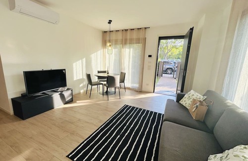 Alba Apartment | Elegant newly built apartment, located on the ground floor. Internally it consists of entrance on living room and kitchenette, double bedroom, twin bedroom, two bathrooms with shower. To complete the property large private garden and double outdoor parki